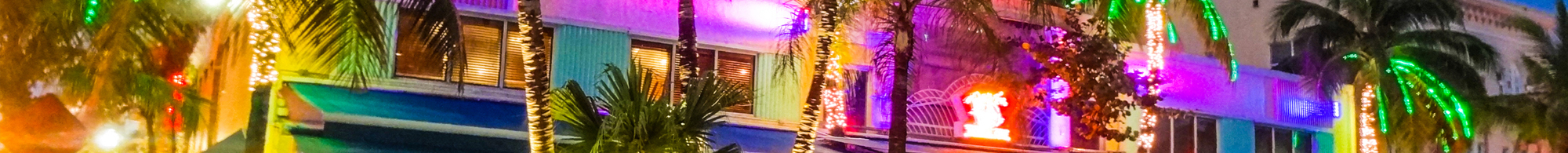 shot of a Miami street with neon lighting up the night